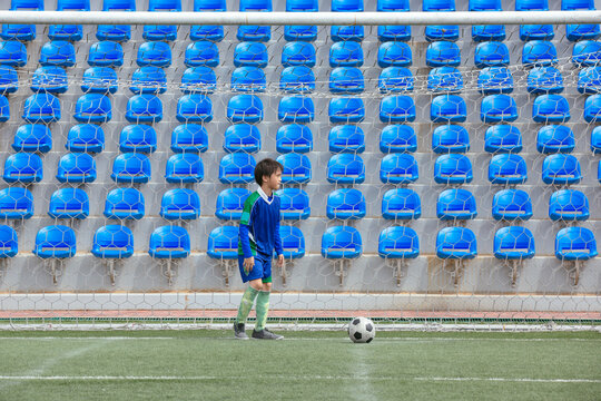 Young football player preparing for a corner kick in a game