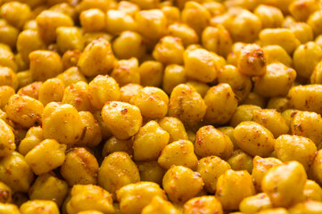 Cooking chickpeas with spices in a pan, close-up