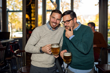 Friends in pub drinking beer and talking