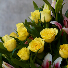 Bunch of yellow roses and lilies.