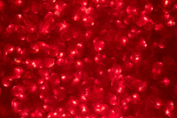 Red color bokeh lighting background. glittering blurred texture.