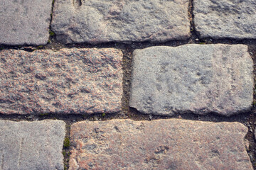 Texture of stone pavement tiles on a road.