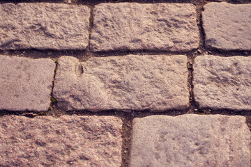Texture of stone pavement tiles on a road.