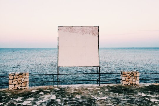 Blank Billboard by the sea at evening