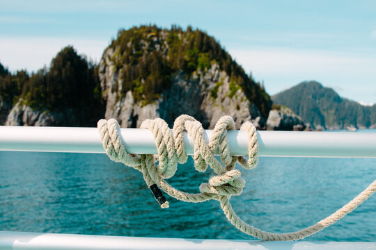 A White Rope Coiled Around The Rail Of A Cruise Ship