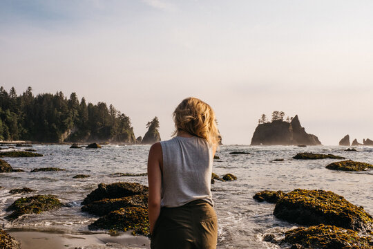 young female hiking and exploring rock formations and caves in northwest usa