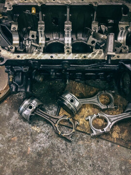 Pistons from a vehicle engine in a garage