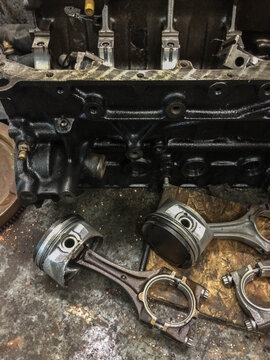 Pistons from a vehicle engine in a garage
