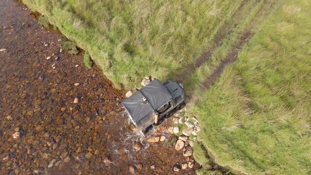 ATV All Terrain Vehicle Driving Through a River