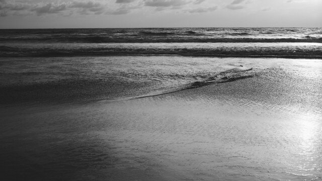 Interesting waves form on the beach at sunset