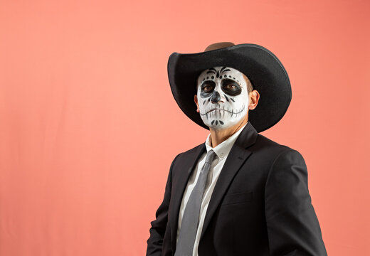 Man with catrin makeup wearing a hat