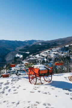 an old red cart in a snowy landscape