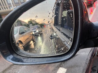 The side view mirror shows many cars get the traffic jam.