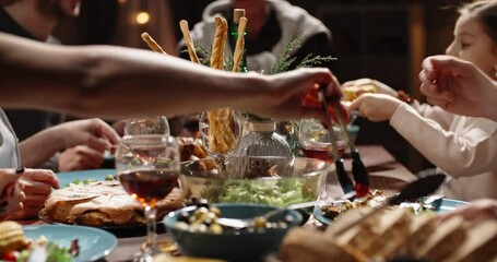 Happy members of large caucasian family toasting to a wish, clinking their glasses during christmas family gathering and dinner xmas party - real people, celebration concept 4k footage - Powered by Adobe