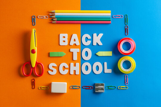 Schools supplies on a Blue and Orange Cardboards with Back to School Message