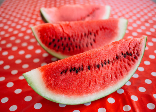 Fresh watermelon slices on the red table