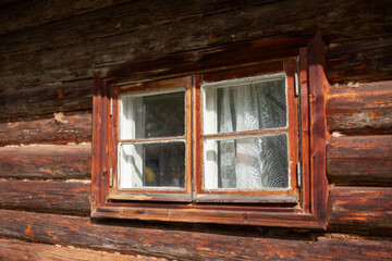 Window in the wall made of wood. Old jlm.