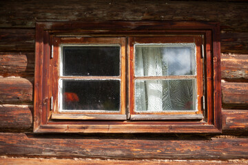 Window in the wall made of wood. Old jlm.