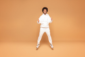 Fototapeta na wymiar Positive afro man jumping up
