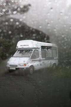 Ice cream van viewed through a rainy windscreen