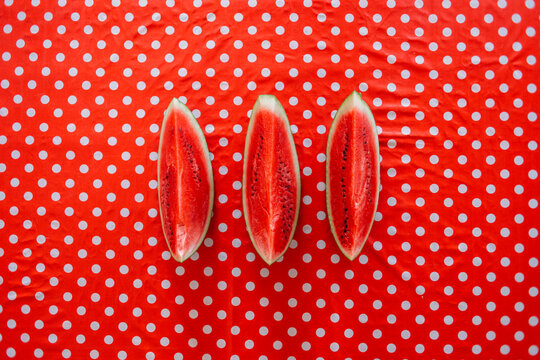 Fresh watermelon slices on the red table