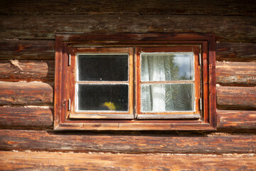 Window in the wall made of wood. Old jlm.