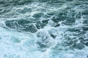 Fototapeta na wymiar Waves and foam on the sea surface. abstraction. background.