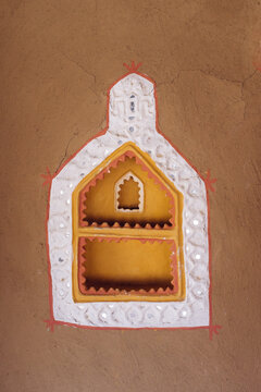 Decorated art mud wall of a traditional hut in India