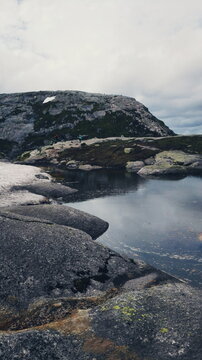 Small lake and snowy patch on the Kjeragbolten hike, Norway