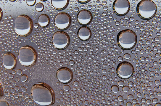 closeup macro macrophotograph of water droplets condensed on a clear surface