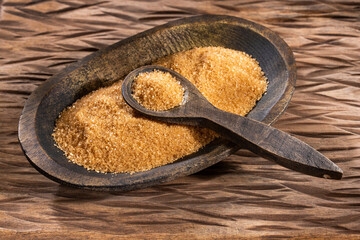 Organic brown sugar in the wooden bowl - Saccharum officinarum