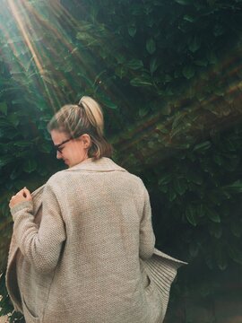 Girl Dancing in a Sweater in the Sunshine