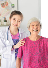 asian female doctor talk about disease symptom with patient in hospital, doctor hug old patient, they feeling good, elderly healthcare promotion