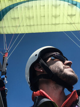 Close up of young man paragliding