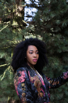 Portrait of young beautiful black woman looking away outdoors