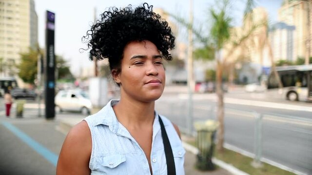 Young black mixed race woman walking in downtown city