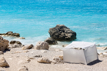 Makeshift Shelter from the Sun on a Rocky Beach
