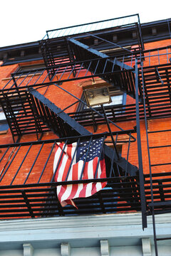 American flag holding from an emergency exit of an apartment.