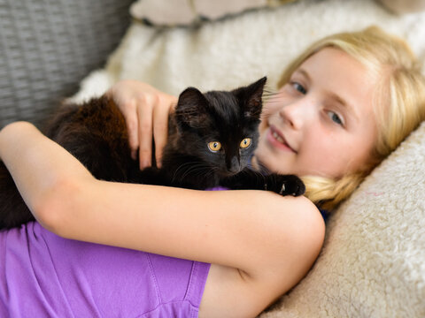 Happy Little Girl Snuggling With Rescued Stray Kitten