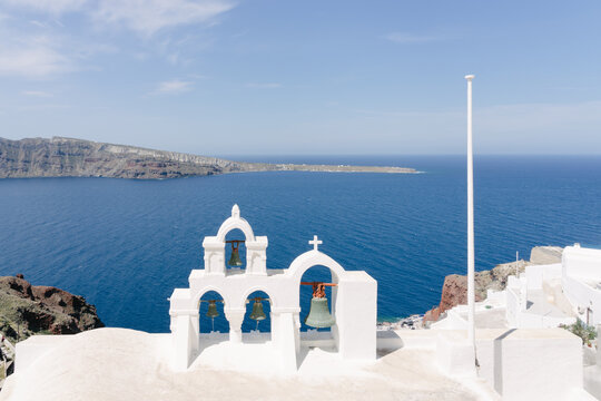 View of sea and white washed church bell tower, Oia, Santorini, Cyclades, Greece
