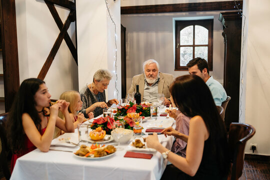 Mother, father, kids and grandparents eating their Christmas meal