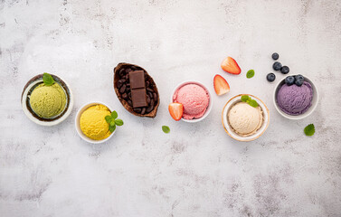 Various of ice cream  flavours in bowl blueberry ,green tea ,coconut ,strawberry and chocolate  setup on white stone background . - 380485396