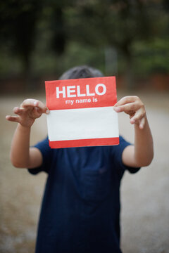 Young kit holding a napkin with the words hello my name is