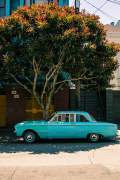 A blue vintage Ford Falcon sitting on a San Francisco street