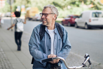 Happy senior man with his bicycle