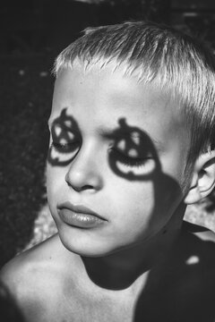 blond boy with pumpkin shadow on the eyes, Halloween