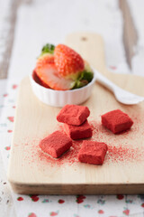 Strawberry chocolate garnished with powder on a wooden plate