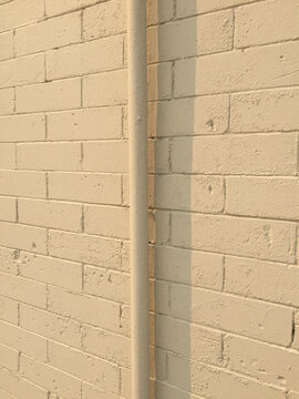 Gutter pipe and brick wall, close up