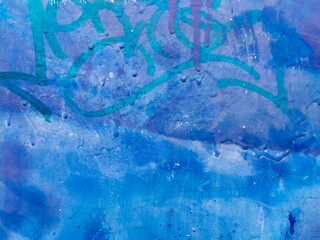 Blue paint and graffiti tags on mailbox, close up