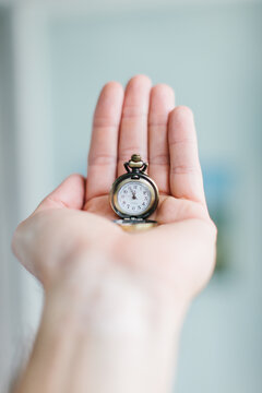 Hand holding mini pocket watch